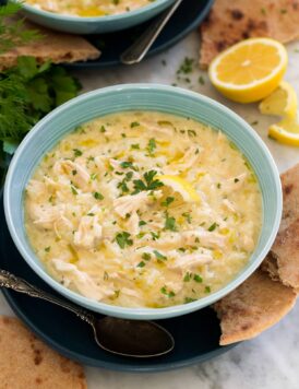 Avgolemono Soup in a turquoise soup bowl.