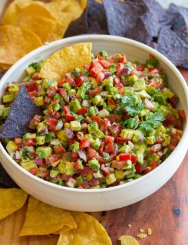 Avocado salsa shown with tortilla chips for dipping.