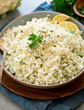 Photo of cauliflower rice shown from the side in a serving bowl.