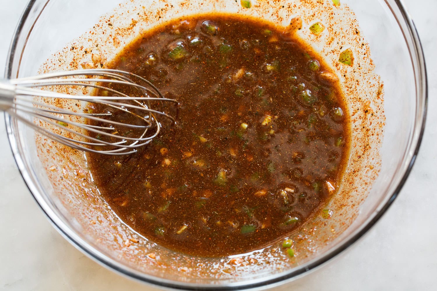 Chicken fajita marinade shown after mixing in glass mixing bowl.