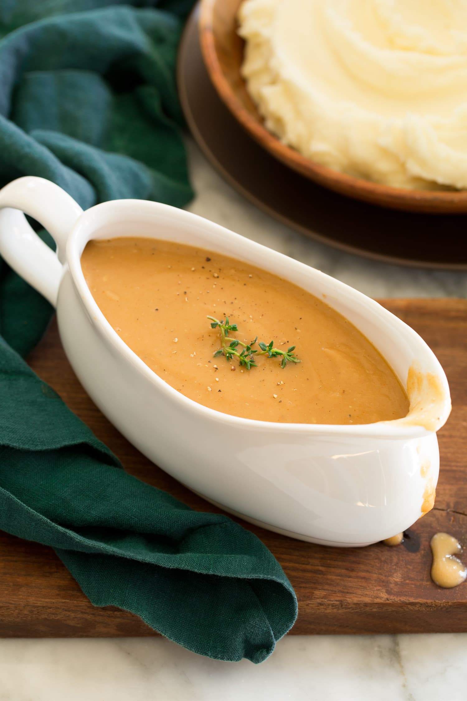 Homemade chicken gravy in a gravy dish.