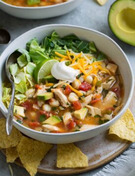 Chicken Pozole in a single serve bowl set over a plate.