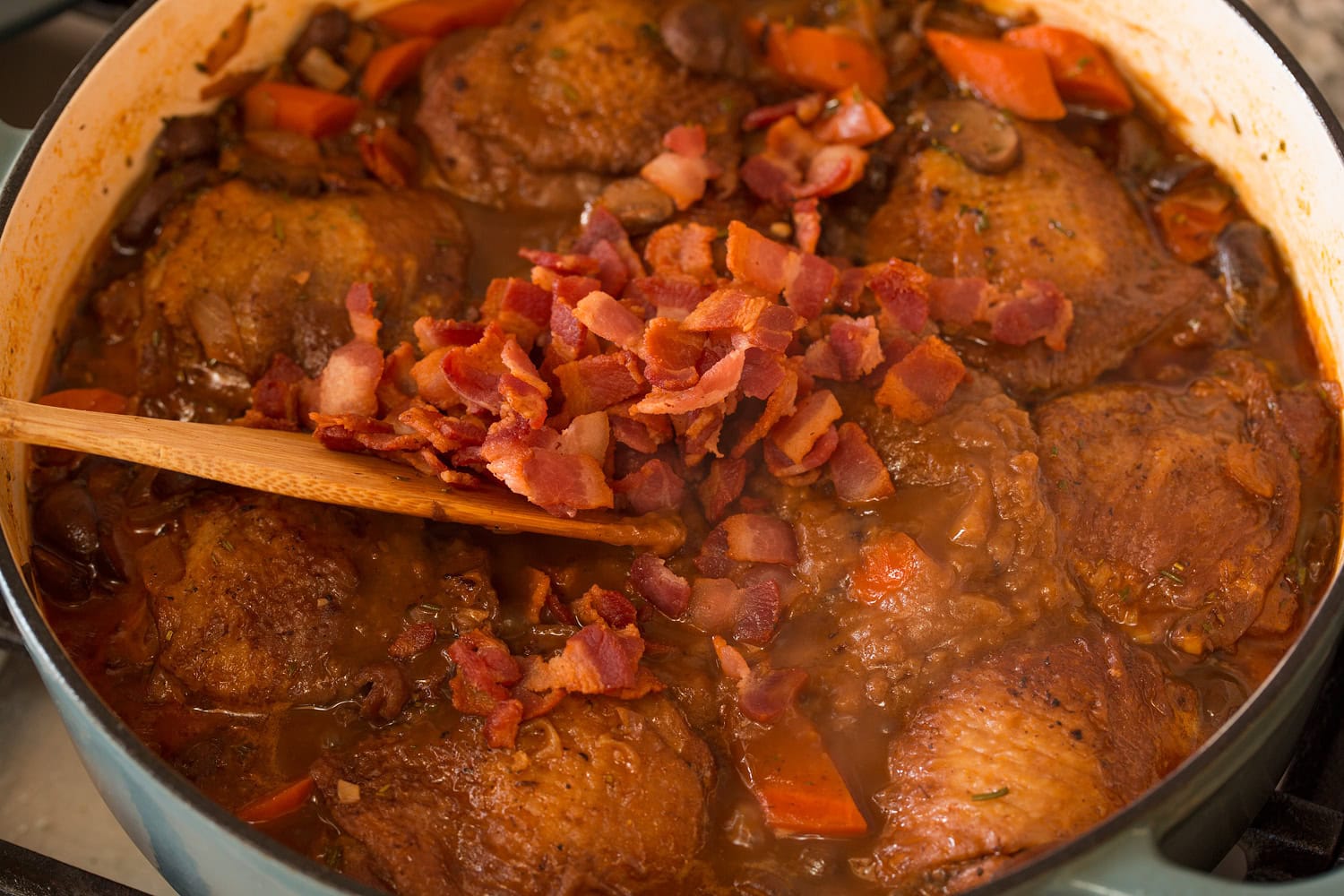 Bacon and sauce added to coq au vin.