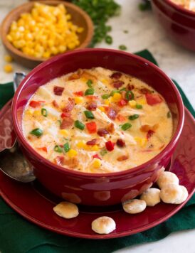 Chicken corn chowder in a serving bowl with oyster crackers to the side.