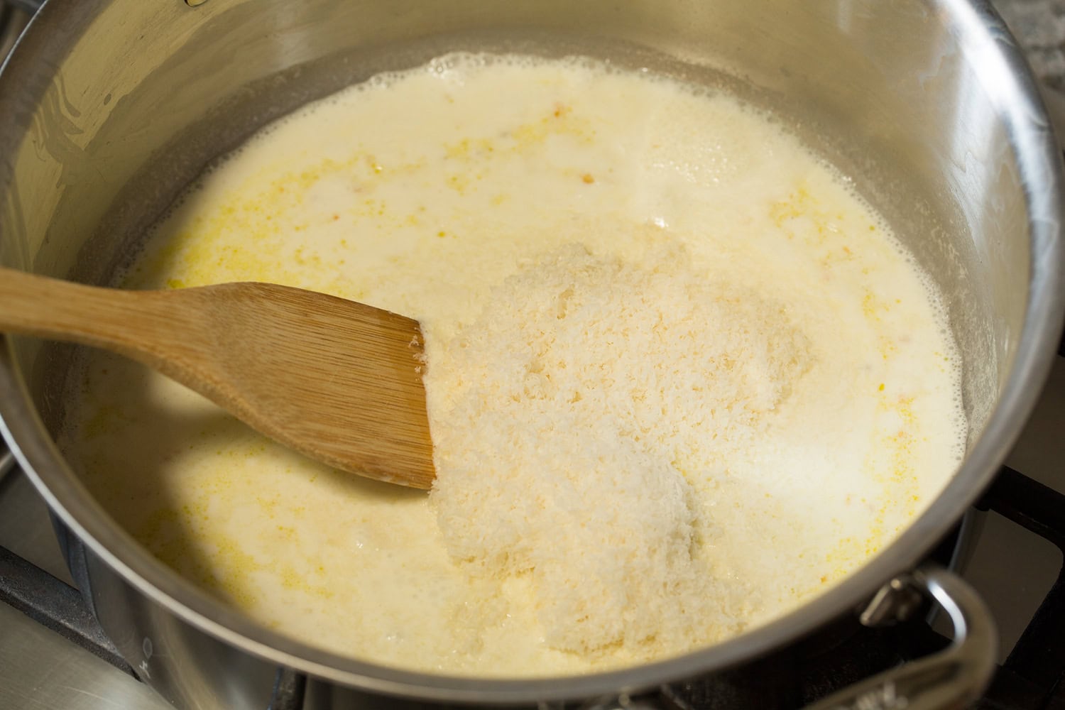 Cream and parmesan in a pot cooked together.