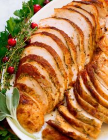 Close up photo of cooked crockpot turkey breast with herbs.