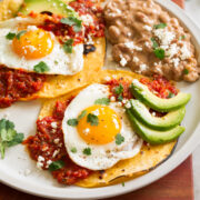 Huevos rancheros served tortillas, salsa ranchero, fried eggs, avocado, and cotija.