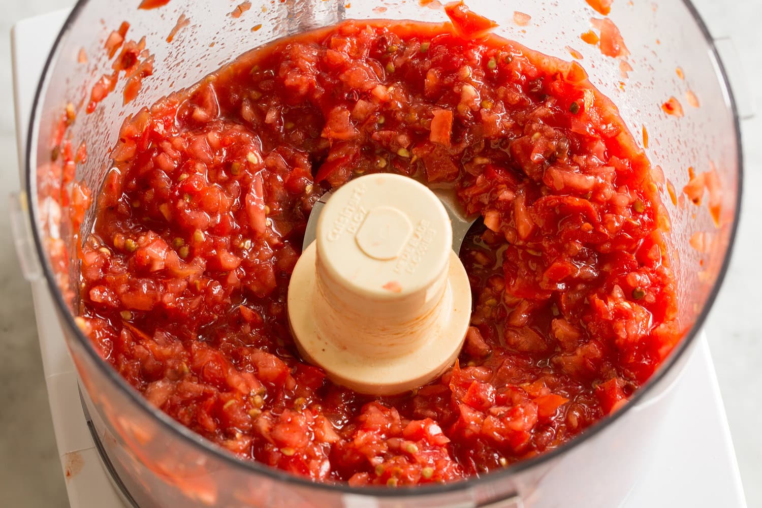 Minced fresh tomatoes in food processor.