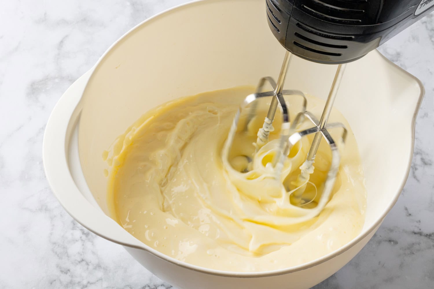 Pie mixture being blended with electric hand mixer.