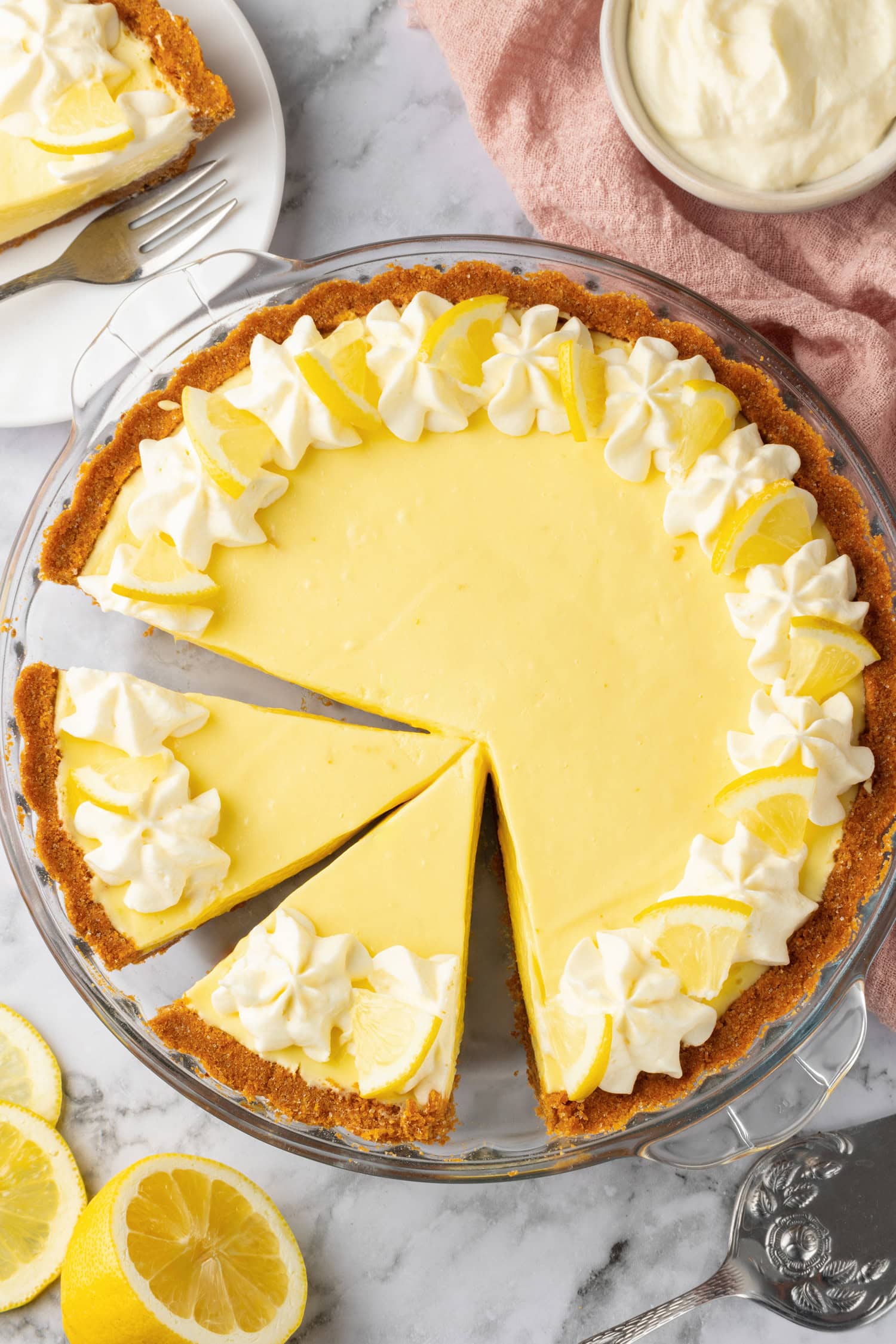 Lemon icebox pie shown from above. Two slices are cut from whole pie.