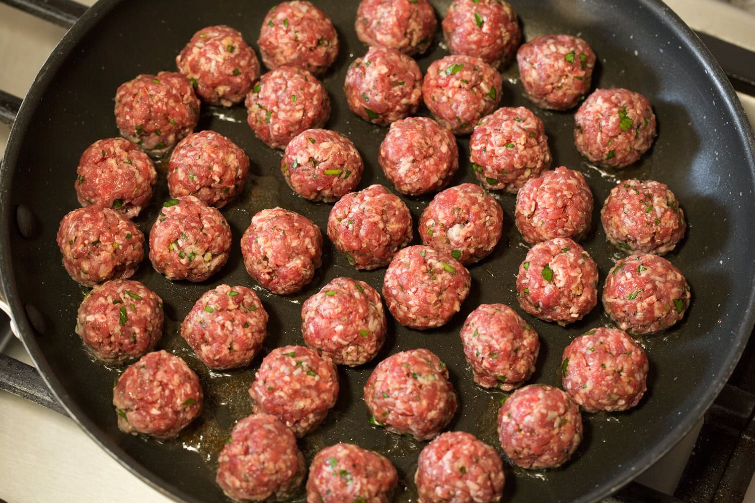 Meatballs in skillet before browned.