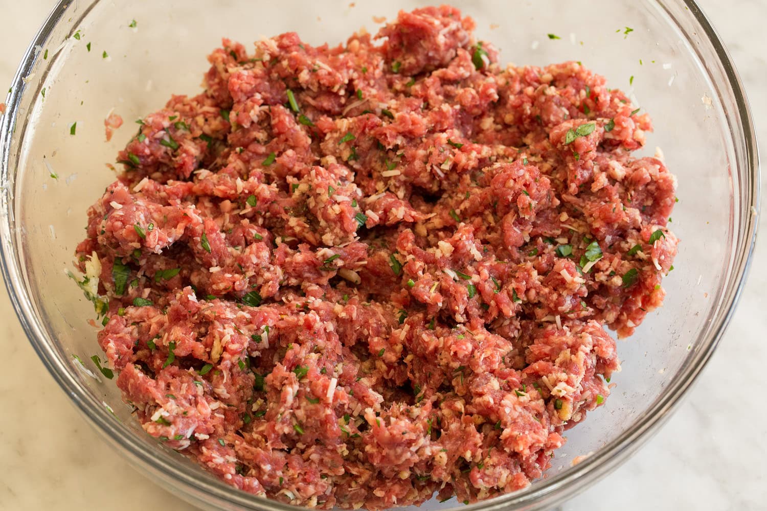 Meatball mixture in mixing bowl shown after mixing.