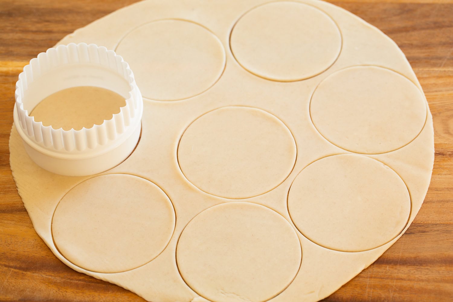 Pie crust cut into individual circles for muffin pan.