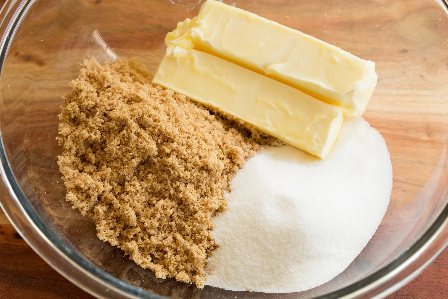 Butter and sugar in glass bowl before mixing.