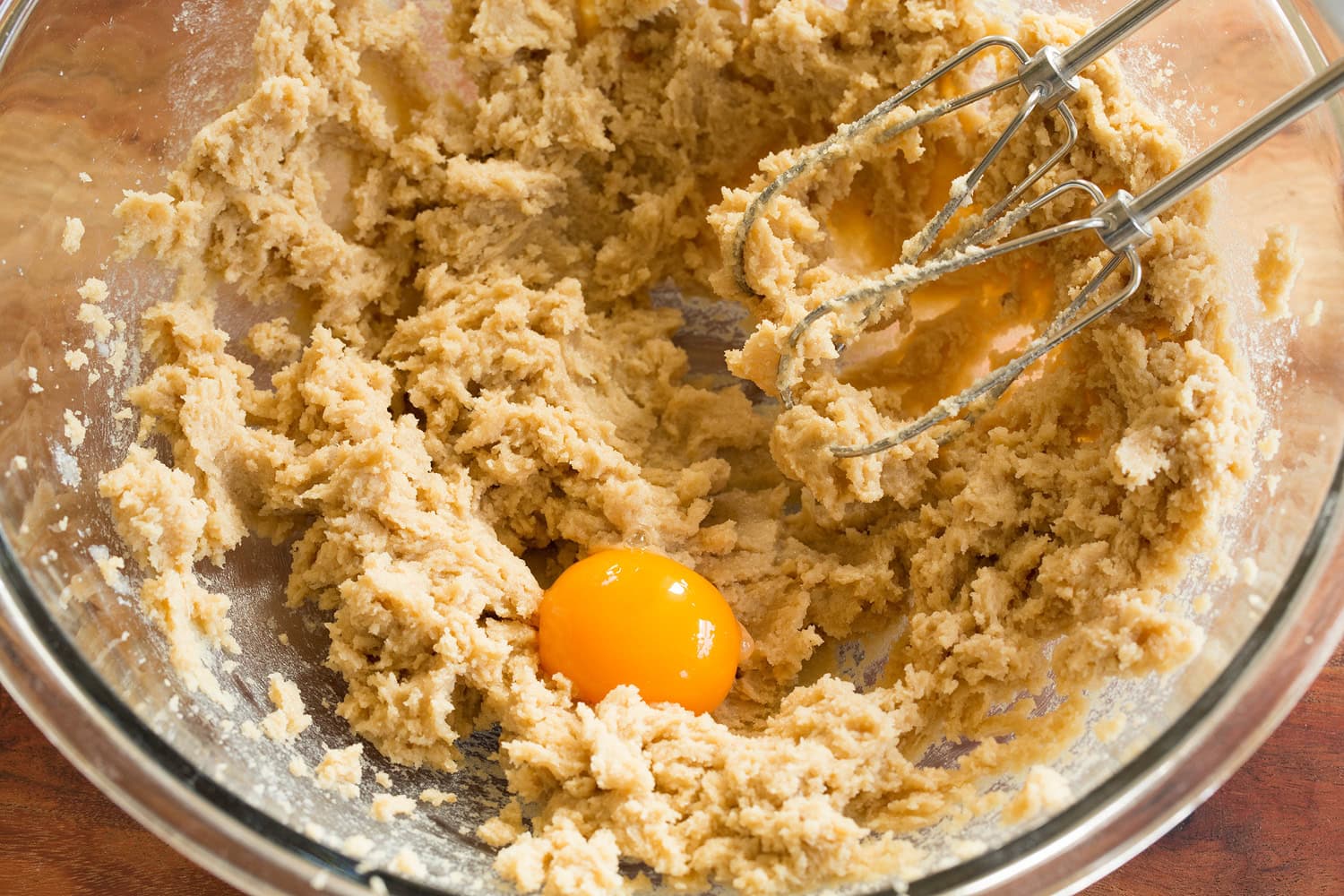 Creamed butter in bowl with egg yolk added.