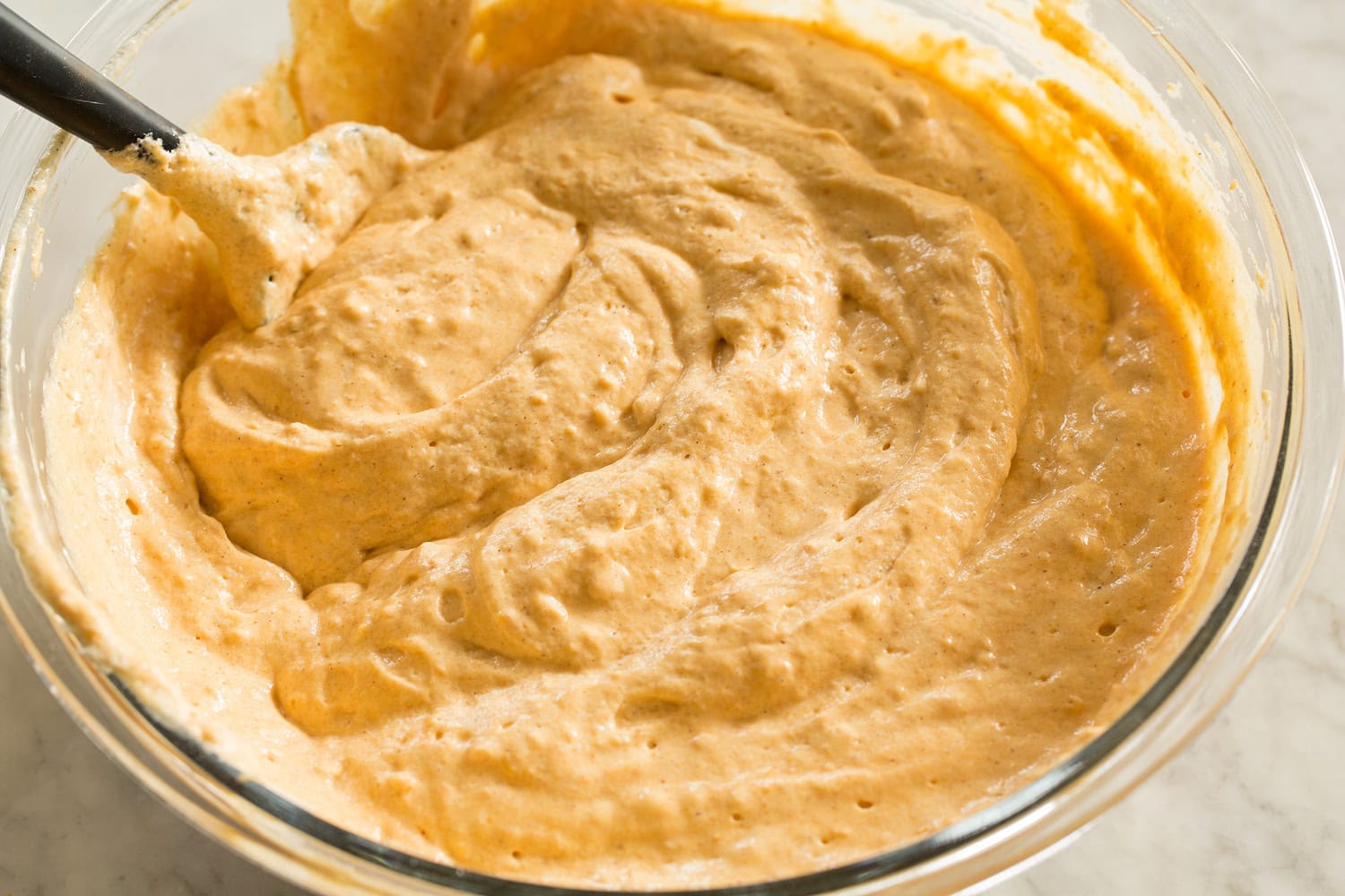 Finished pumpkin waffle batter in a mixing bowl.