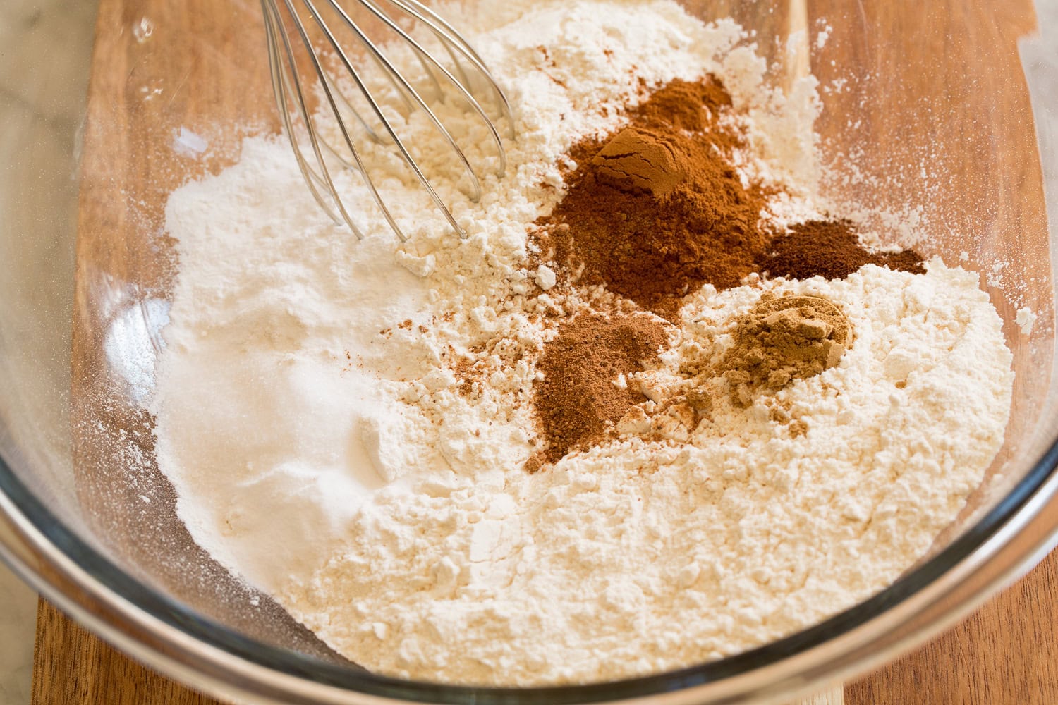 Mixing flour and spices for pumpkin waffles.