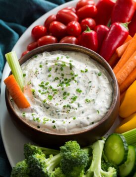 Close up photo of ranch dip in a wooden bowl.