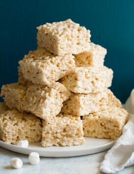 Stack of cut rice krispie treats on a platter.