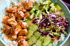 Salmon rice bowl with teriyaki style salmon, cucumber, cabbage, avocado and sriracha mayo.