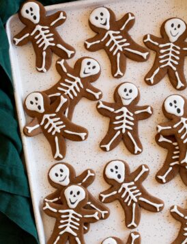 Gingerbread cookies with skeleton bodies piped over with white icing.