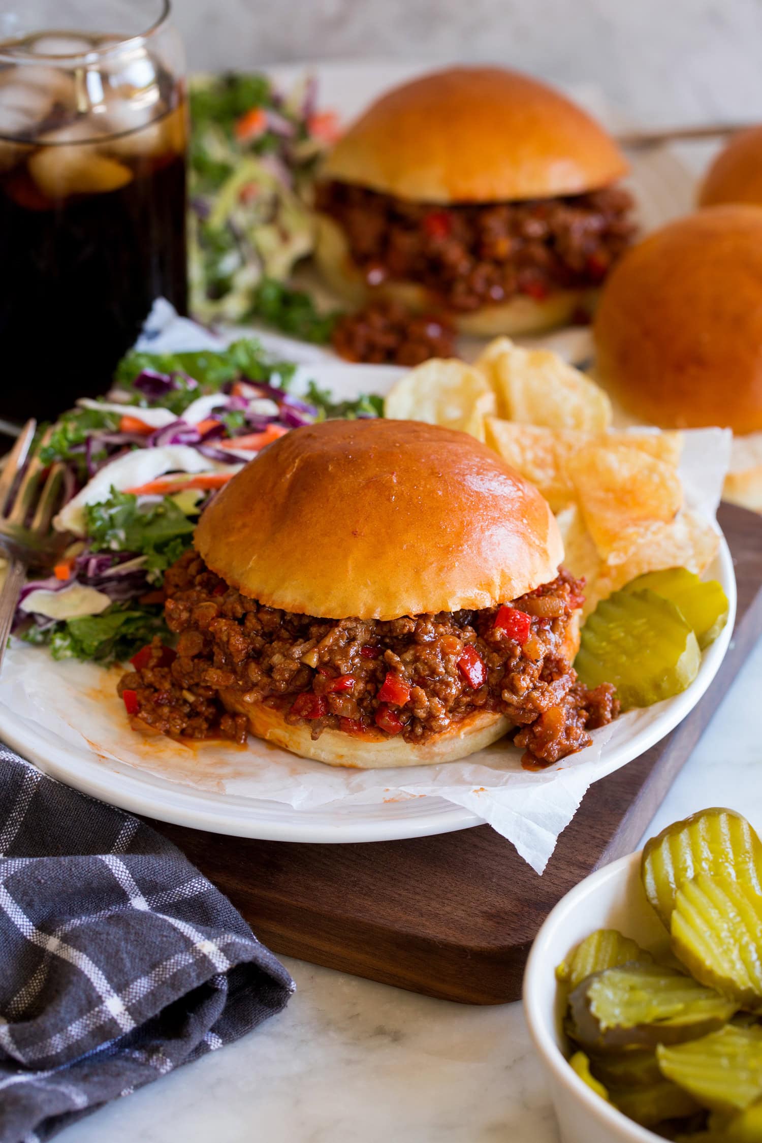 Sloppy Joes on a homemade hamburger bun. Served with potato chips, pickles and coleslaw to the side.