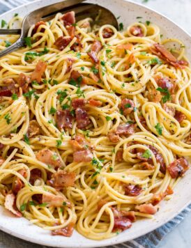 Pasta carbonara shown in a large white serving bowl.