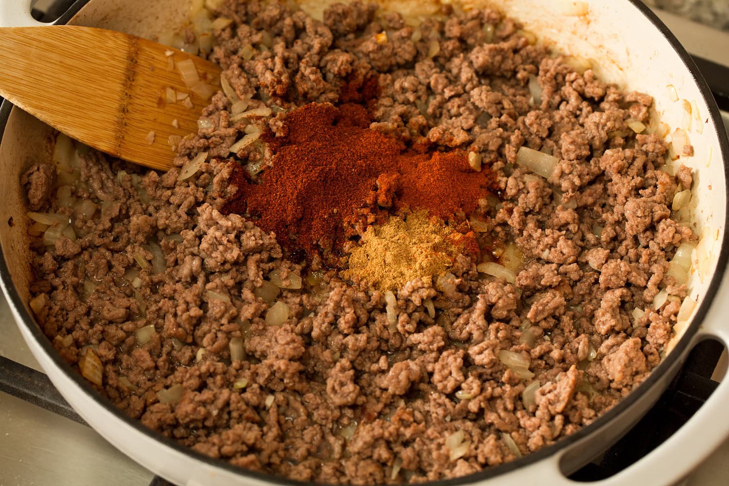 Adding spices to browned beef.